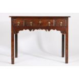 George III oak lowboy, with two short and one long drawer above a pierced carved apron, on square