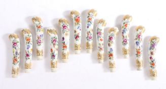 Set of twelve George III English porcelain knife handles, circa 1800, the pistol grip form handles