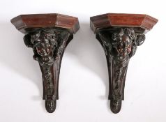 Pair of 19th century mahogany wall brackets in the form of putti/cherubs, the winged putti with a