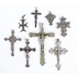Collection of eight silver and white metal Corpus Christi and crosses one stamped 800, the largest