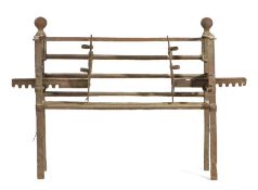 An 18th century wrought iron bar-grate The front of five bars, the upper bar dropping to form a