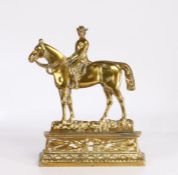 Cast brass "Dr Jim" doorstop, modelled as a figure on horseback above a crossed spear and scroll