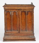 Gothic Revival oak two door cupboard, the doors and sides with Gothic style tracery, the doors