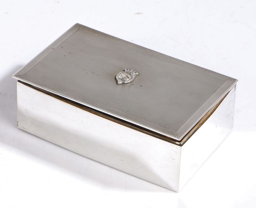 Prince George, Duke of Kent interest, a silver cigarette box, the engine turned lid with central