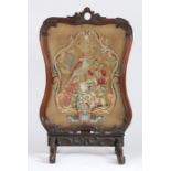 Large Victorian oak framed fire screen, the carved shaped frame inset with a needlework panel of a