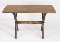 19th Century oak and pine trestle table, the oak top with rounded corners, raised on dark stained