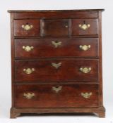 George III oak chest of two short and three long drawers, with central cupboard and brass swan