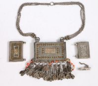 Three Islamic white metal Koran or Quran boxes, the largest with hanging chain, bells and