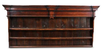 An 18th century oak dresser rack Having a bold breakfront cornice,  end-pendant frieze, boarded