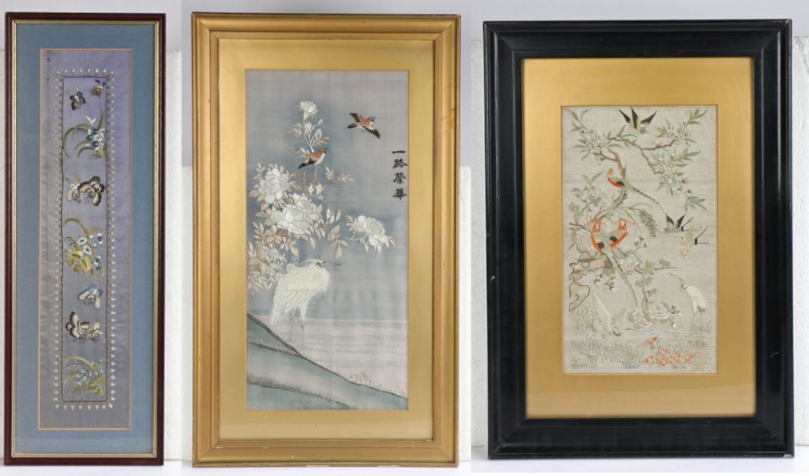 Chinese silk needlework picture depicting a crane and birds on a blossoming branch, housed in a gilt