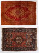 Two Turkish rugs, one with red and blue ground set with a central motif, with a floral repeating