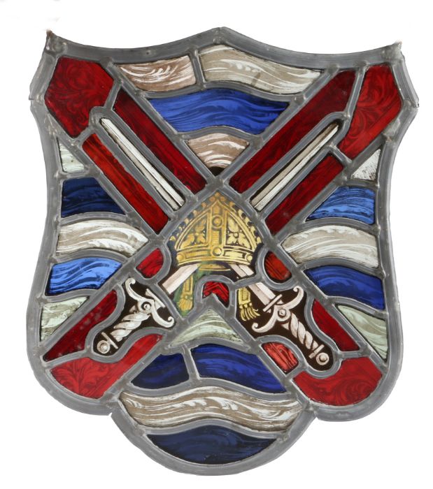 A stained glass panel, of shield shape, designed with crossed swords, 24cm wide, 28cm high