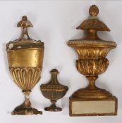 Three gilt urn form architectural panels, the largest with pineapple form finial and acanthus leaf