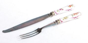 Meissen porcelain handled knife and fork, circa 1740, the handles with puce scroll and polychrome