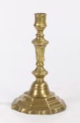 George III brass candlestick, circa 1760, the octagonal sconce above a conforming waisted stem and