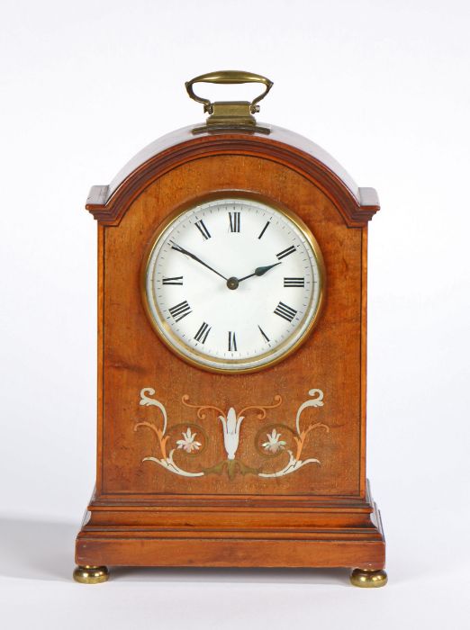 Edwardian inlaid mahogany mantle clock, with an arched pediment with a brass carrying handle above a