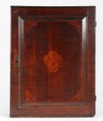 A George III oak and marquetry-inlaid mural cupboard, circa 1780 The single fielded panelled