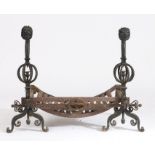 Unusual pair of cast iron fire dogs, the lions head terminals above pierced rope twist orb form