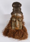 An early 20th Century Kuba mask, Democratic Republic of Congo, the pigmented decorated face with