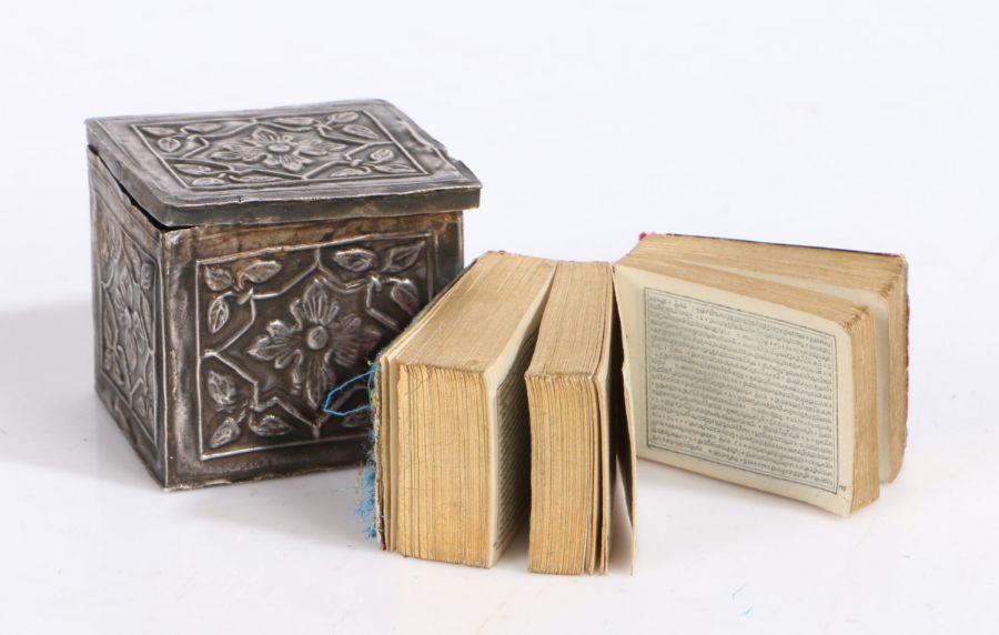 Miniature Quran/Koran, the book with foliate needlework covers, housed in a foliate embossed white