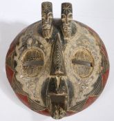 Gabon Bakota or Kota mask, of circular form, decorated in red and black with applied white metal