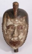 West African tribal mask, possibly Igbo people, Nigeria, the stylised bird form pediment above a red