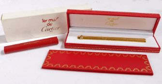 Les must de Cartier gold plated ballpoint pen, the cap with Cartier logo above a three colour