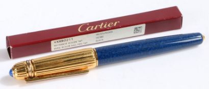 Pasha de Cartier ballpoint pen, the ribbed gilt cap with blue cabochon set terminal, with blue