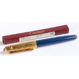 Pasha de Cartier ballpoint pen, the ribbed gilt cap with blue cabochon set terminal, with blue