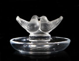 A Lalique ring tray, of circular form surmounted by twin doves, etched mark to base, 9cm diameter