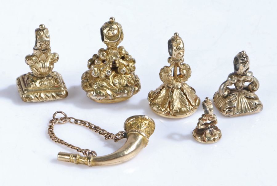 Collection of six gilt fob seals, to include example modelled as a bugle, three with carved