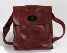 A Mulberry dark claret leather satchel bag, flap with postman's lock, with webbing shoulder strap,
