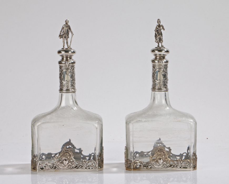 Pair of 19th Century Continental silver mounted bottles/decanters, the figural finials in the form