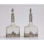 Pair of 19th Century Continental silver mounted bottles/decanters, the figural finials in the form