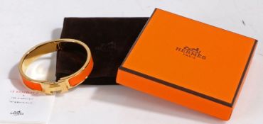 A Hermes Clic H bracelet, orange enamel and rose gold plated, with original suede pouch and box, 6cm