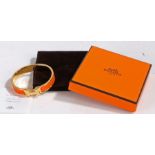 A Hermes Clic H bracelet, orange enamel and rose gold plated, with original suede pouch and box, 6cm