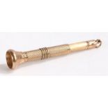 9 carat gold cigar piercer, the engine turned body with flared terminal and sprung mechanism, 8cm
