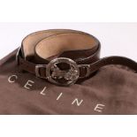 A Celine brown leather adjustable belt, silvered circular buckle with horse and carriage motif,