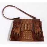 A brown crocodile skin handbag, with claws, gilt metal mounts, suede lined, strap. Purchased on Bond