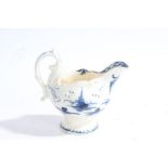 A Derby porcelain creamer, circa 1775, decorated in blue and white with a pagoda above a