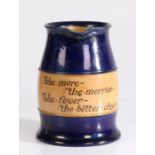 Royal Doulton stoneware pitcher, with two bands of navy blue glaze and text reading "The More -