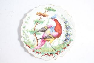 A 19th century Chelsea plate, with a colourful exotic bird to the center with a floral background,