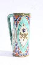Della Robbia pottery mug, c1894-1906, with a blue and green ground set with floral panels, marks