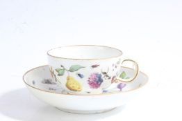 Meissen porcelain tea cup and saucer, painted with flowers, insects and fruit, marked to base, (