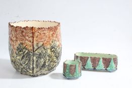 Two majolica pots decorated with green trees on a mottled brown ground with TS marked to the base