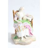 A 19th century porcelain figure, baring Meissen style mark, depicting a lady asleep in a chair