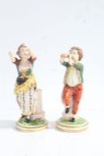 A pair of 19th century figures, baring Derby Marks, one depicting a young boy playing a pipe the