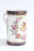 A 19th century French porcelain mug, in the style of Derby, decorated with a floral theme and