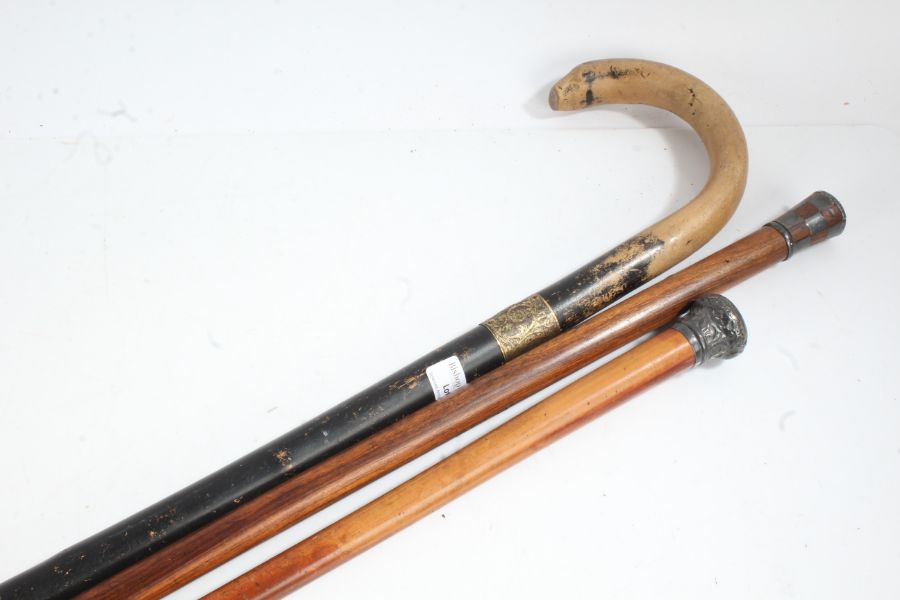 Three various walking sticks to include a Sheppard crook style stick, silver capped example etc (3)