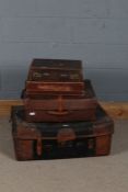 Set of four 20th century leather travelling cases and briefcases, the largest 71cm wide